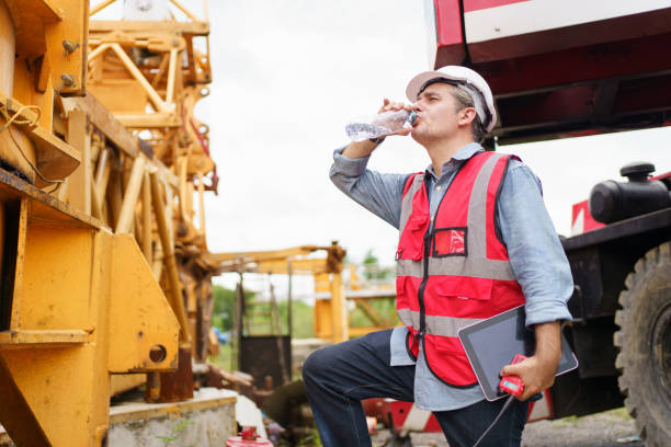 istock Thirsty and tired worker setting on the floor. 2188822345