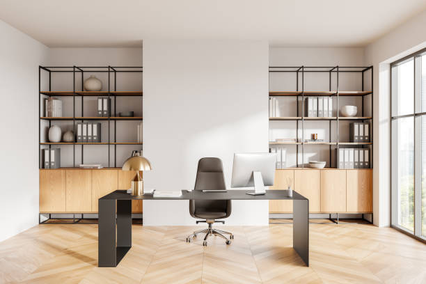 istock Modern minimalistic office interior with large desk, shelving, and natural light from windows. 3D Rendering 2188823546