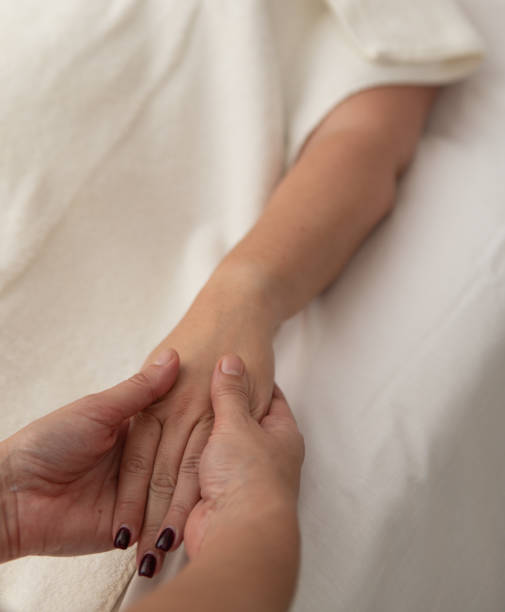 istock Professional masseuse doing arm and hand massage to a client 2188823707