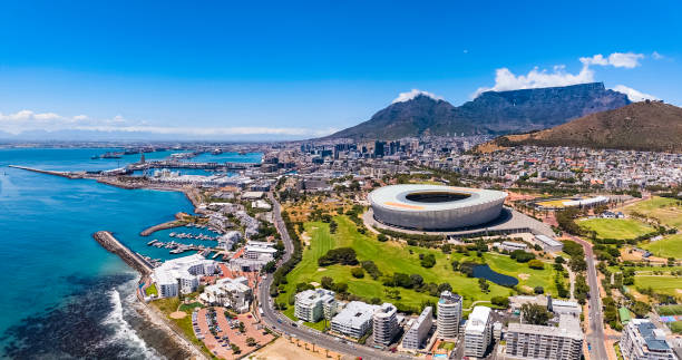 Cape Town V & A Waterfront harbour, Table Mountain and the DHL Stadium with the city centre seen from the sea and showing Green Point.