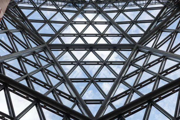 istock A large steel structure with the clear glass window with many triangles and a clear blue sky. 2188824753