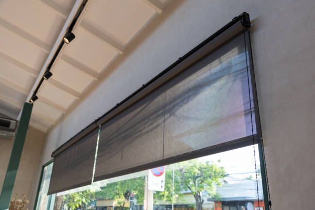 istock A window with a black screen that is open to the outside. black rolling blind curtain with window shop. 2188825025