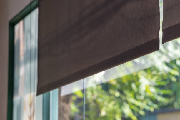 istock A window with a black screen that is open to the outside. black rolling blind curtain with window shop. 2188825027