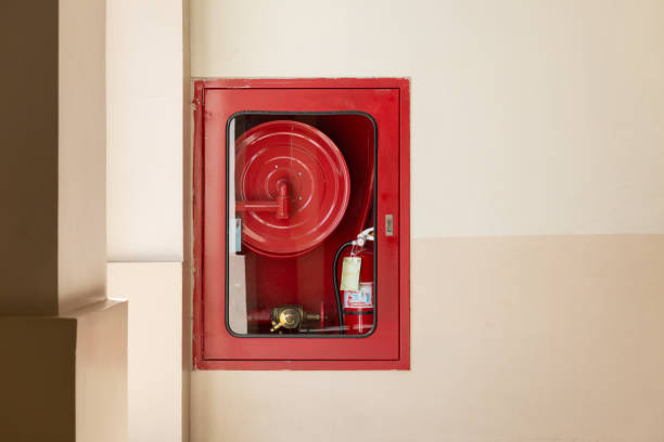 istock A red fire hydrant with a yellow hose attached to it 2188827455