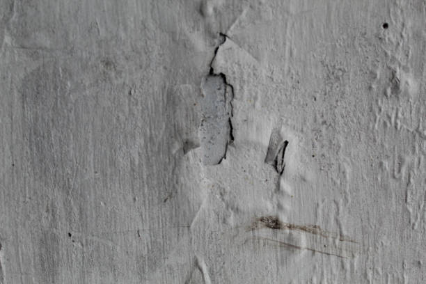 White wall paint peeling due to wet condition