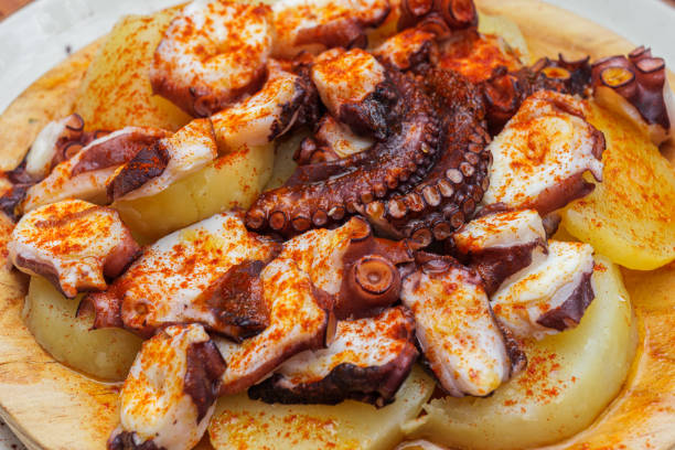 istock Fried octopus with potatoes and paprika on a plate in a restaurant 2188828079