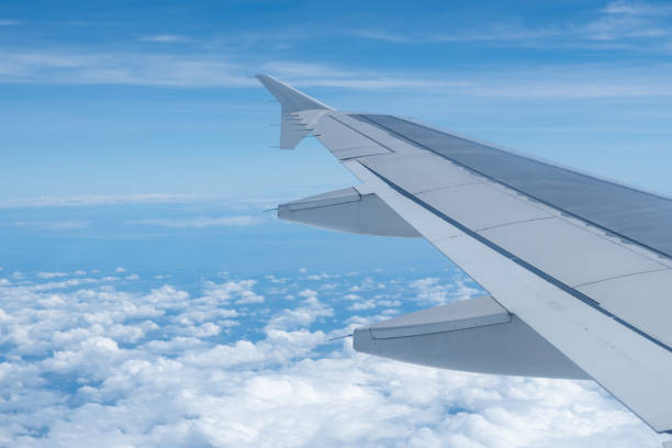 istock Sky and cloud seen from window of airplane, with the plane wing 2188828772