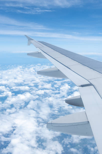 istock Sky and cloud seen from window of airplane, with the plane wing 2188829672