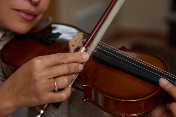 istock Close-up of hands playing a violin with precision and skill 2188829720