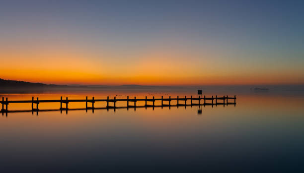 istock Silhouette of jetty on lake at afterglow 2188837347