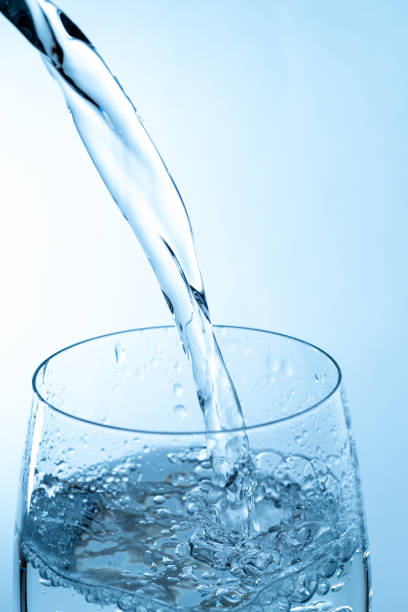 istock Pouring water into a glass 2188837504