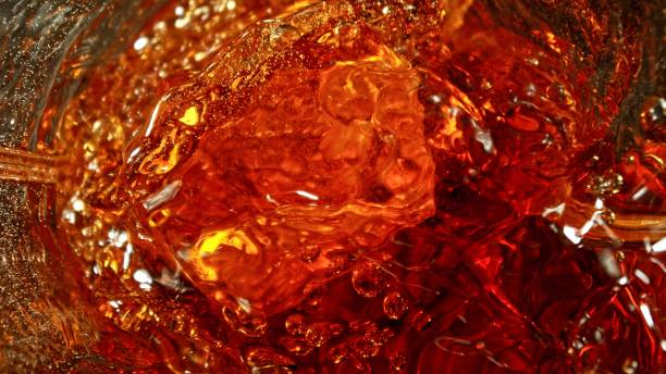 istock Closeup of ice cube inside glass of whiskey. 2188839821