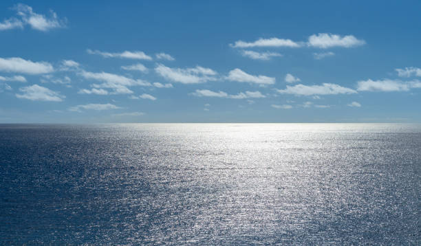 The Atlantic Ocean with sunlight and bleached cloudy skies