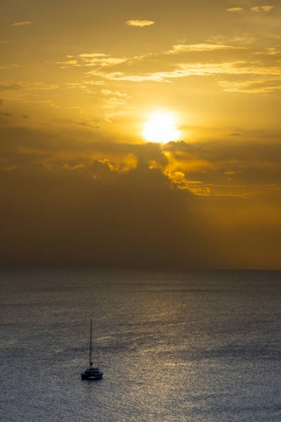 Spain, Fuerteventura, Morro Jable, November 20, 2024 - A sailboat in the sea at sunset
