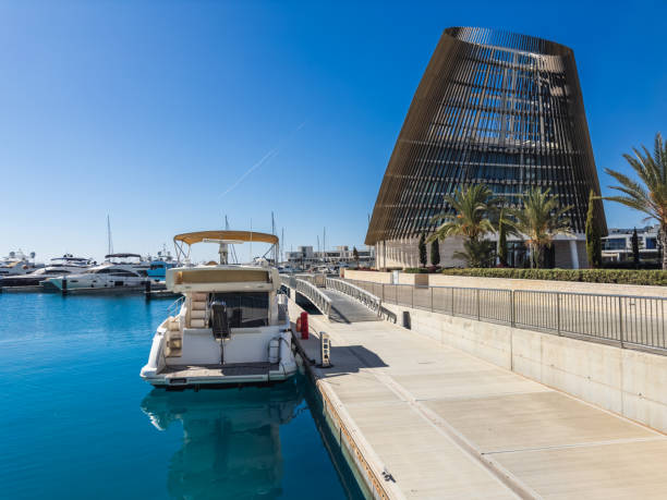 A stunning luxury marina featuring modern architectural design and sleek yachts docked at crystal-clear waters. This picturesque location blends innovation and leisure in a serene waterfront setting.
