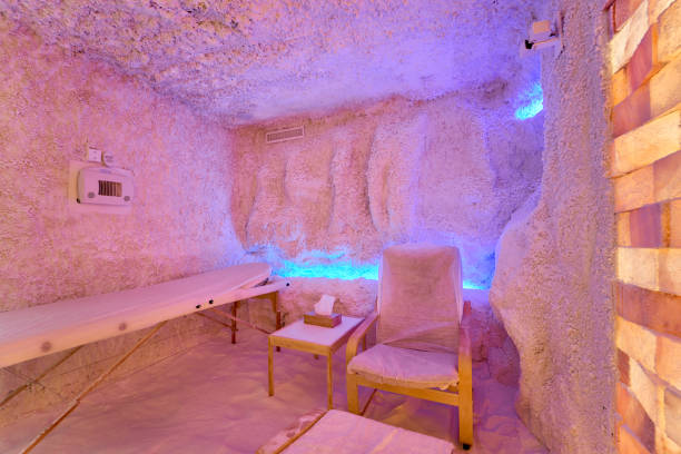 Salt therapy room with massage table and chairs in a relaxing ambiance