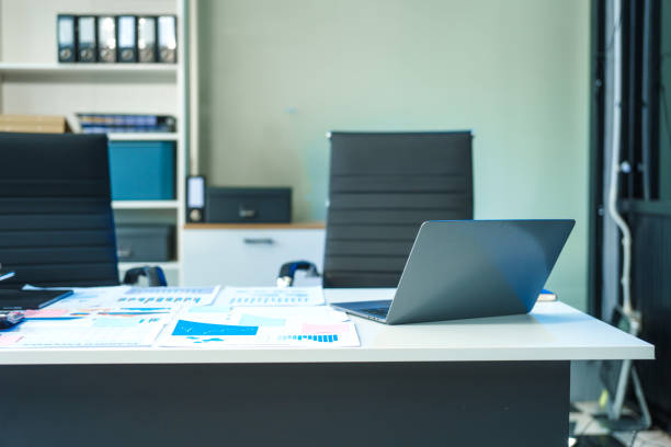 istock An office desk with a chart placed on it, accompanied by a computer, tablet, and chair. The setup creates a professional workspace with no people present 2188846862