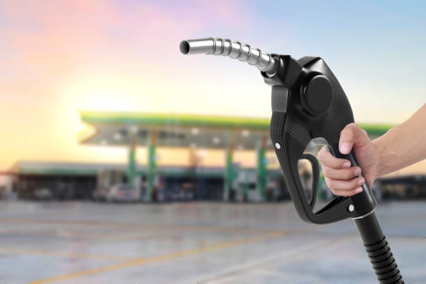 istock Holding a fuel nozzle against with gas station blurred background 2188851410