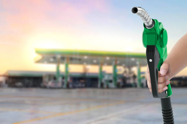 istock Holding a fuel nozzle against with gas station blurred background 2188851411