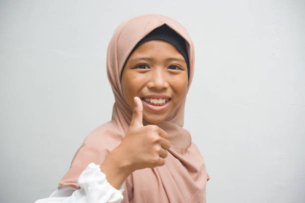 The girl raised her thumbs up