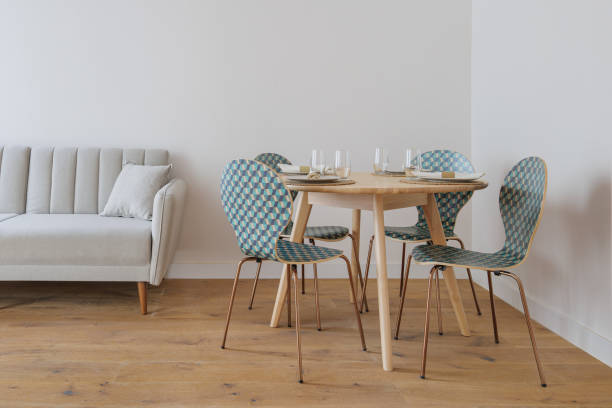 istock Interior of living room modern style with grey fabric sofa, dining table served for few persons and chairs with ornament 2188855621