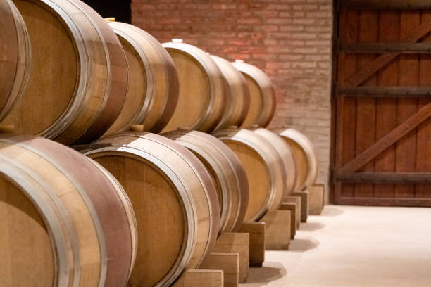 istock Set of oak barrels stacked inside a winery. 2188857382