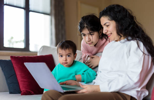 istock Mom and two kids using educational app on laptop 2188858273