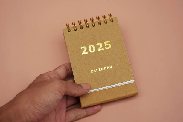 istock A hand holding a desk calendar for 2025 2188858453