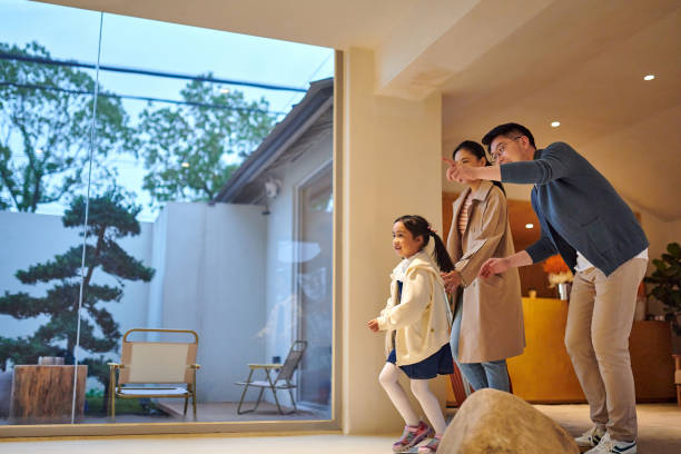 Side view of asian family looking over at hotel lobby.