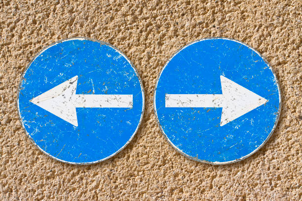 istock Old blue metallic arrow sign against a plaster wall indicating to go left and right - concept image 2188862966