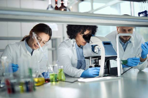 istock Female scientist working on a research through a microscope in laboratory. 2188863300