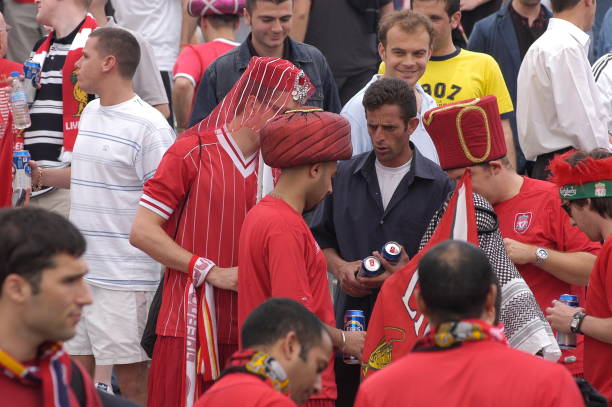 Taksim Square - Istanbul, Turkey - May 25, 2005: Liverpool football team fans drink lots of beer and have fun while waiting for game time in Taksim Square before the UEFA CHAMPIONS LEAGUE FINAL match against Milan on May 25, 2005 in Istanbul, Turkey. The season final was played at the Istanbul Atatürk Olympic Stadium between Liverpool of England and Milan of Italy. The regular time and extra time ended 3-3 in the final, and Liverpool won the championship by defeating Milan 3-2 in the penalty shootout.