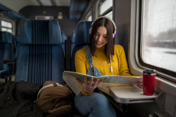 istock A young trendy traveler is sitting next to a train window and looking through it. 2188865306