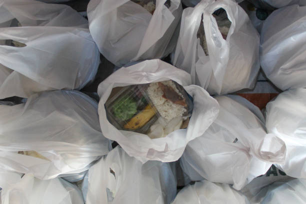 istock White plastic bag contain food package to be distributed. Flat lay or top view 2188865320