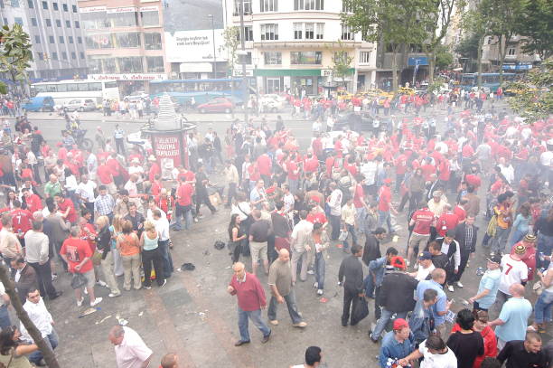 Taksim Square - Istanbul, Turkey - May 25, 2005: Liverpool football team fans drink lots of beer and have fun while waiting for game time in Taksim Square before the UEFA CHAMPIONS LEAGUE FINAL match against Milan on May 25, 2005 in Istanbul, Turkey. The season final was played at the Istanbul Atatürk Olympic Stadium between Liverpool of England and Milan of Italy. The regular time and extra time ended 3-3 in the final, and Liverpool won the championship by defeating Milan 3-2 in the penalty shootout.