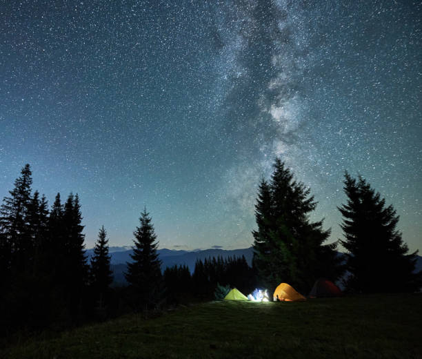 istock Night camping in mountains under starry sky. 2188869536