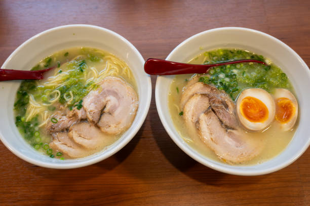 Two Bowls of Japanese Tonkotsu Ramen Noodles, Pork and Soft Boiled Eggs