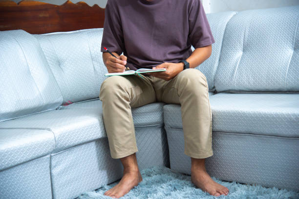 bank man working on computer with calculators and stock charts in the kitchen of his home.