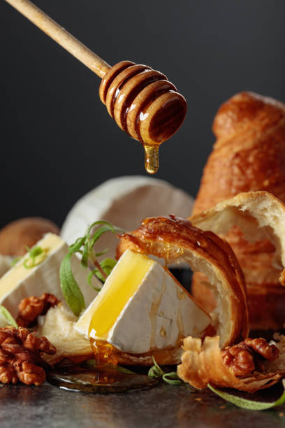 istock Camembert cream cheese with honey, croissants, and walnuts. 2188870937