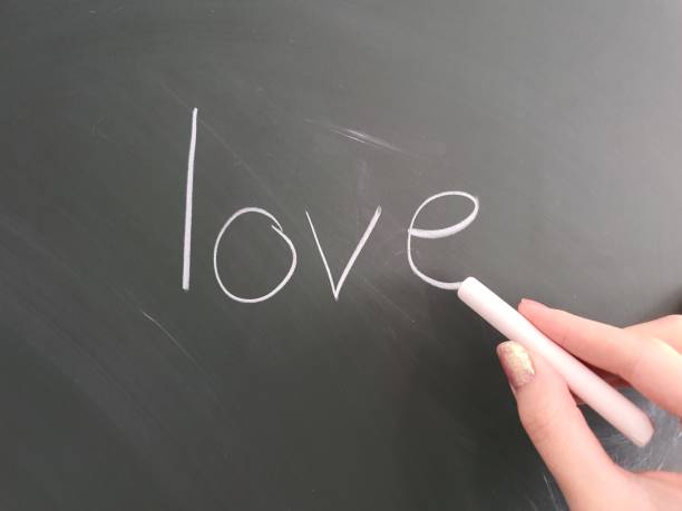 istock Student at school writing the word LOVE on a chalkboard 2188873044