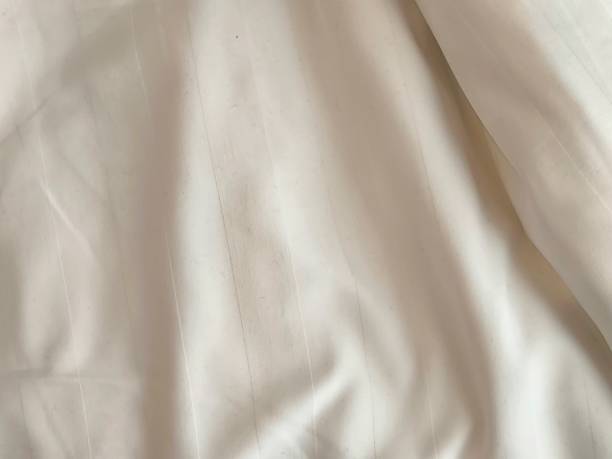 istock Clean silky bed linen. White fabric background. Bedding sheet. Messy fabric texture 2188874153