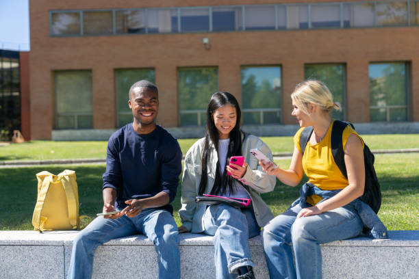 istock Multiethnic students sharing content on smartphones at university campus 2188874225