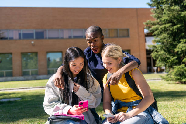 istock Multiethnic students sharing fun on smartphones at university campus 2188874226