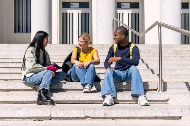istock Multiethnic students chatting on university steps on a sunny day 2188874571