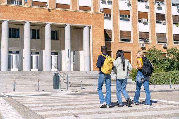 istock Multiethnic students walking on crosswalk to university campus 2188874620