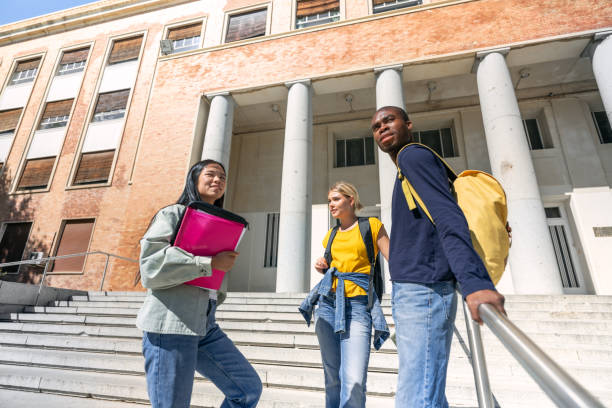 istock Multiethnic students walking upstairs on university campus 2188874639