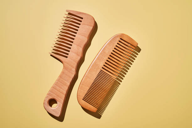 istock Two wooden combs on a yellow background. 2188875664