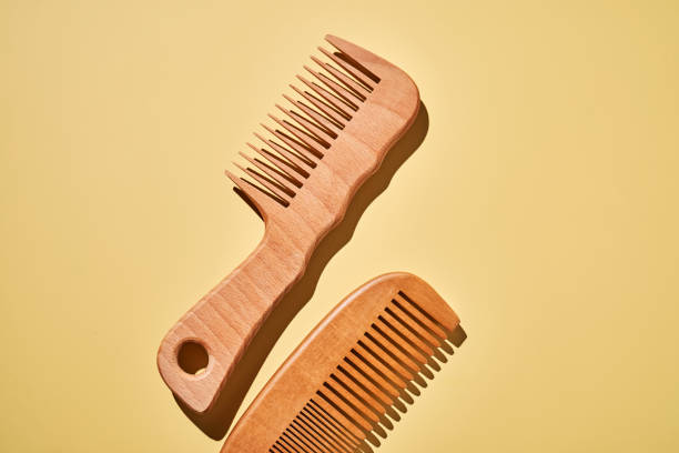 istock Two wooden combs on a yellow background. 2188875681
