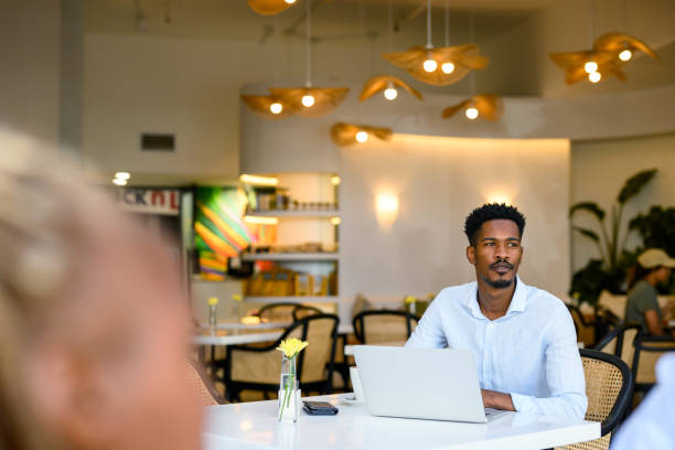 istock Man working on laptop in cafe area of shared office space working in a peaceful environment 2188875751