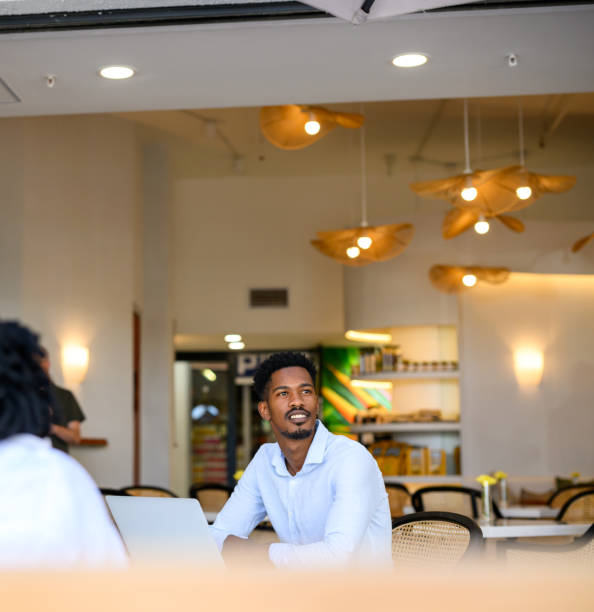 istock Man working on laptop in cafe area of shared office space working in a peaceful environment 2188875775